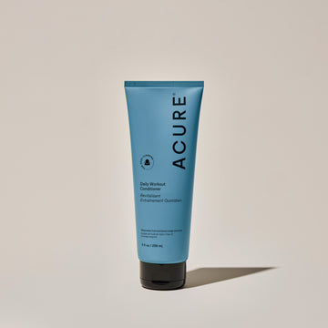 A tube of ACURE Daily Workout Conditioner against a neutral background.